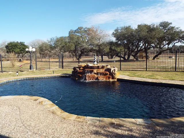 a view of swimming pool with outdoor seating