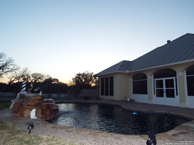 a view of a yard with wooden fence