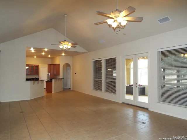 a view of a livingroom with a ceiling fan and window