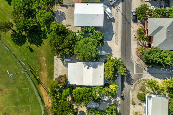 an aerial view of a house with a yard