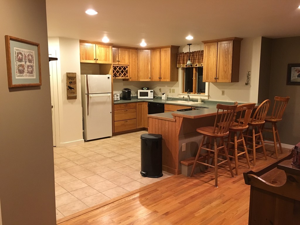 17 Crest Road Monson, MA 01057 - Photo 4 of 11 a kitchen with stainless steel appliances kitchen island granite countertop a refrigerator and a stove top oven
