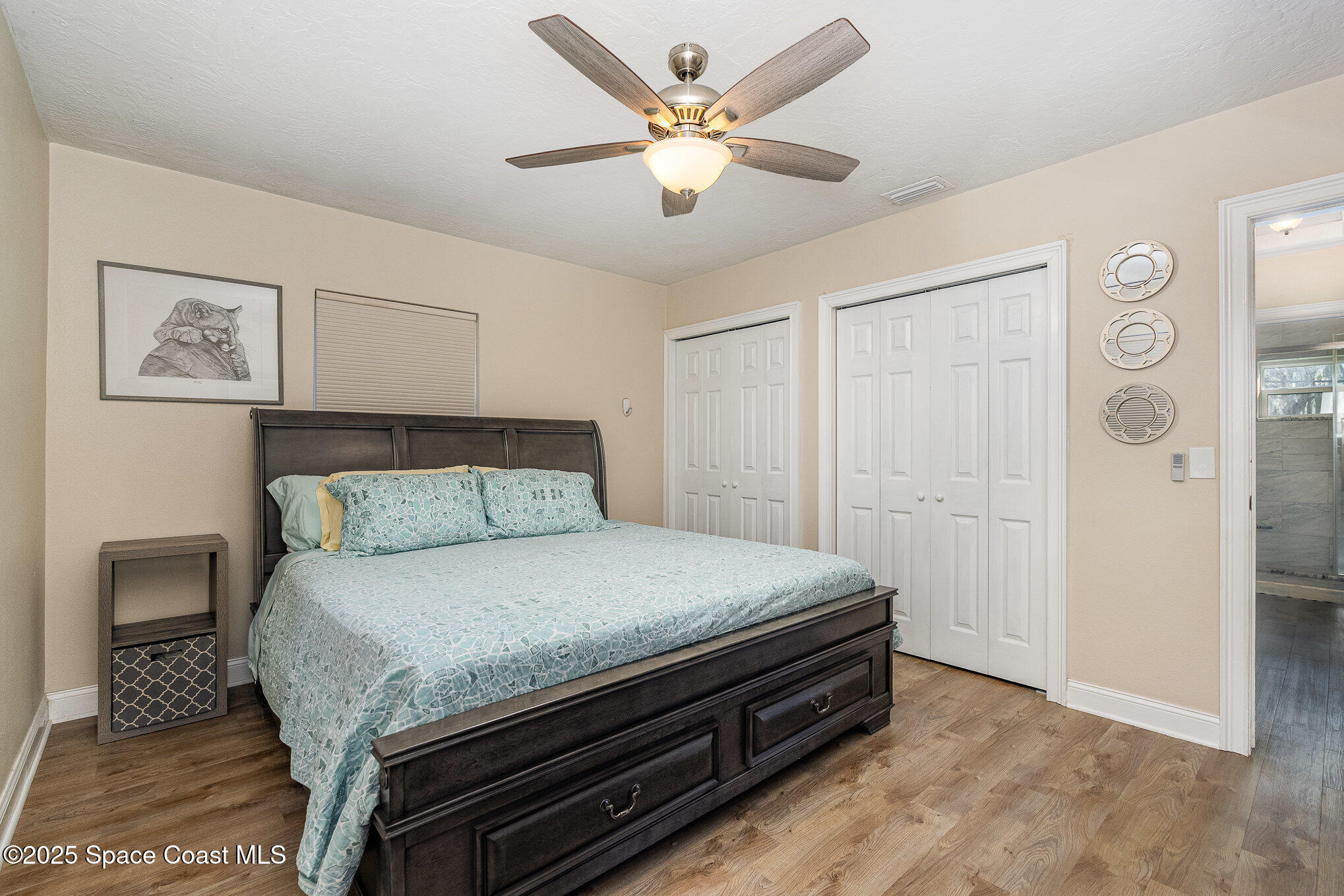 701 Espanola Way Melbourne, FL 32901 - Photo 14 of 29 a bedroom with a bed and a ceiling fan