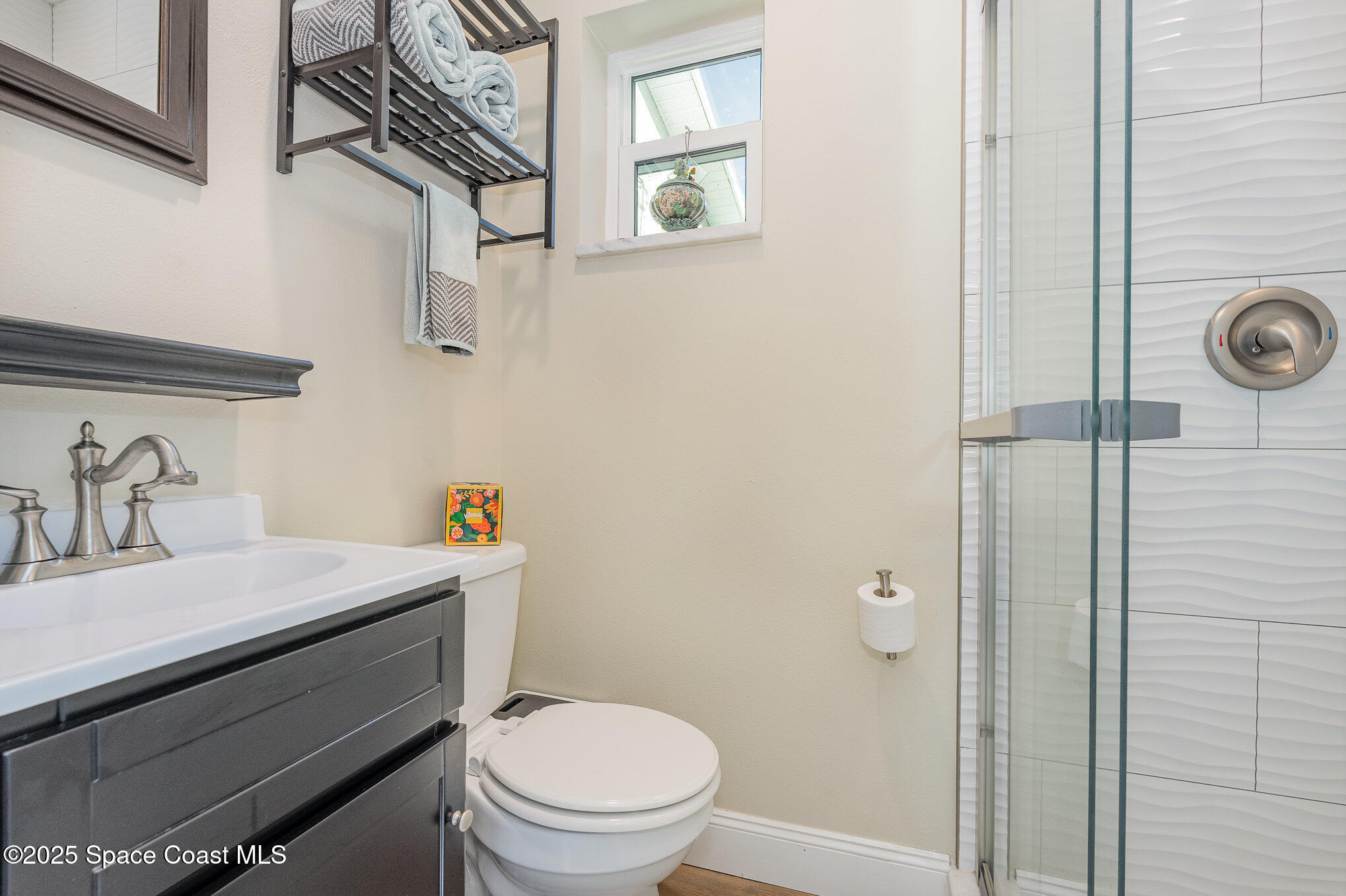701 Espanola Way Melbourne, FL 32901 - Photo 15 of 29 a bathroom with a sink a toilet and shower