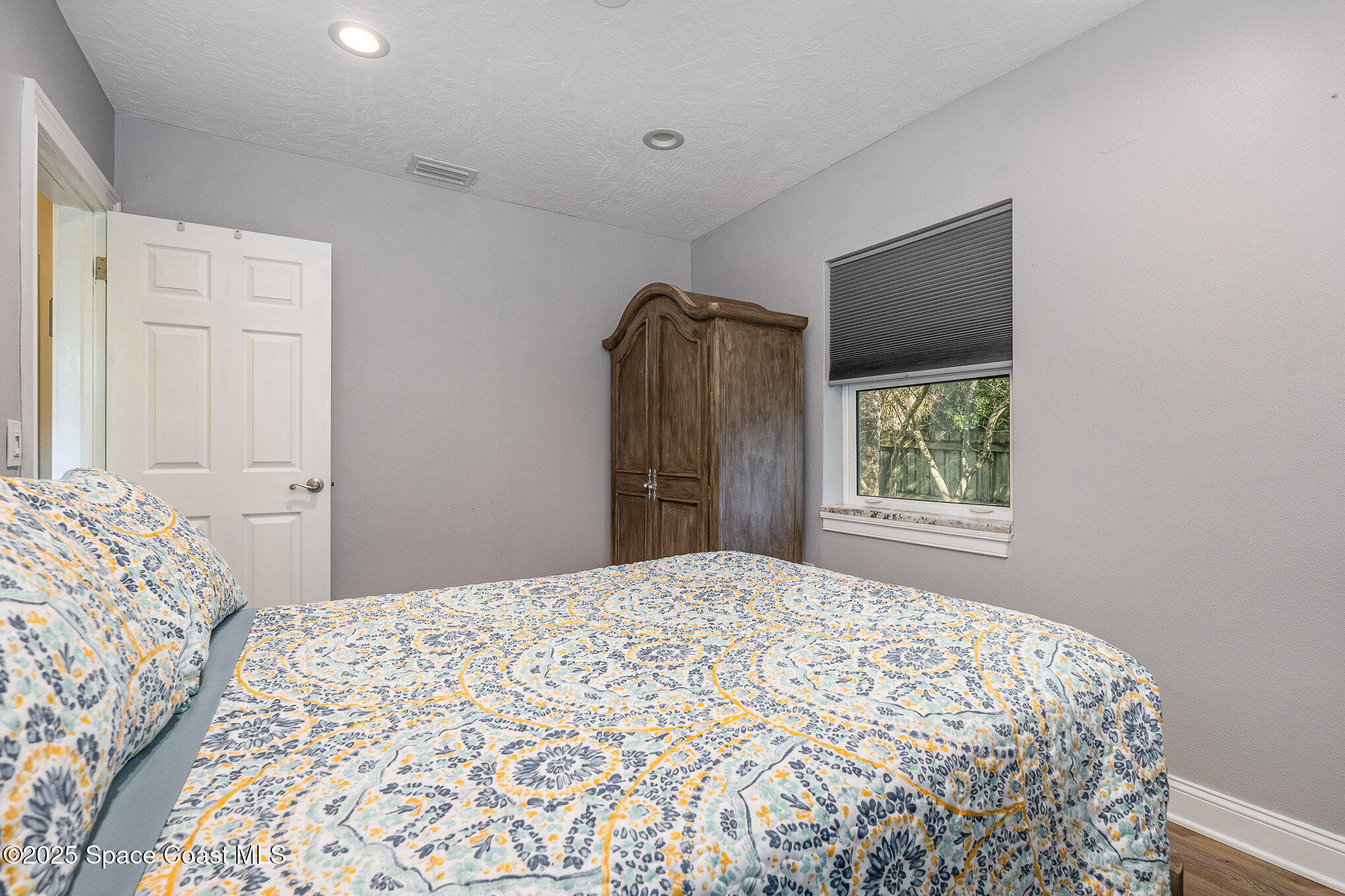 701 Espanola Way Melbourne, FL 32901 - Photo 19 of 29 a bedroom with a bed and a window