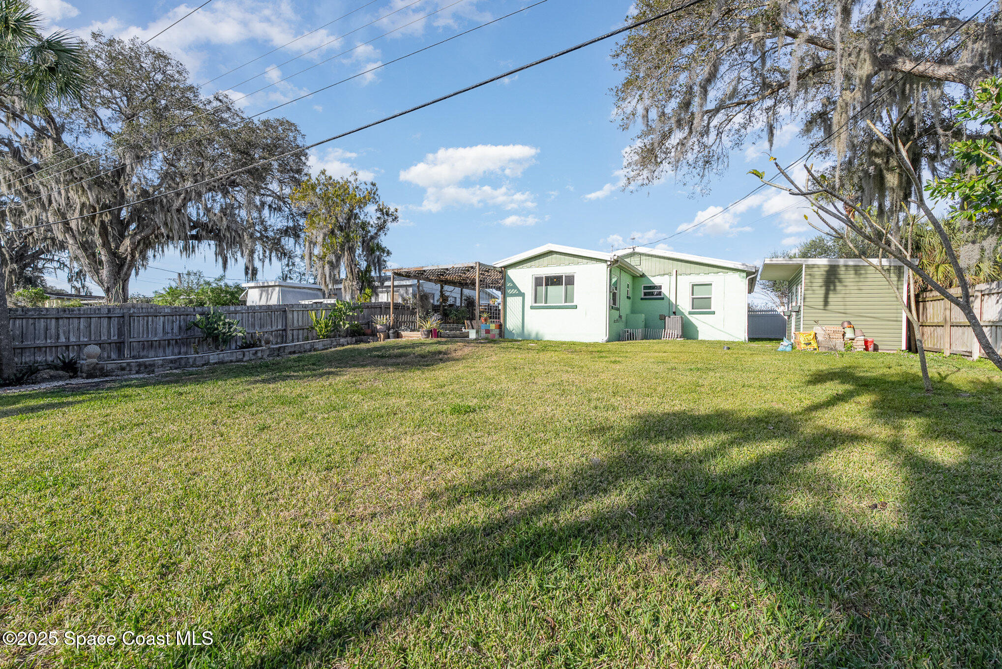 701 Espanola Way Melbourne, FL 32901 - Photo 25 of 29 a view of a house with a big yard and large trees