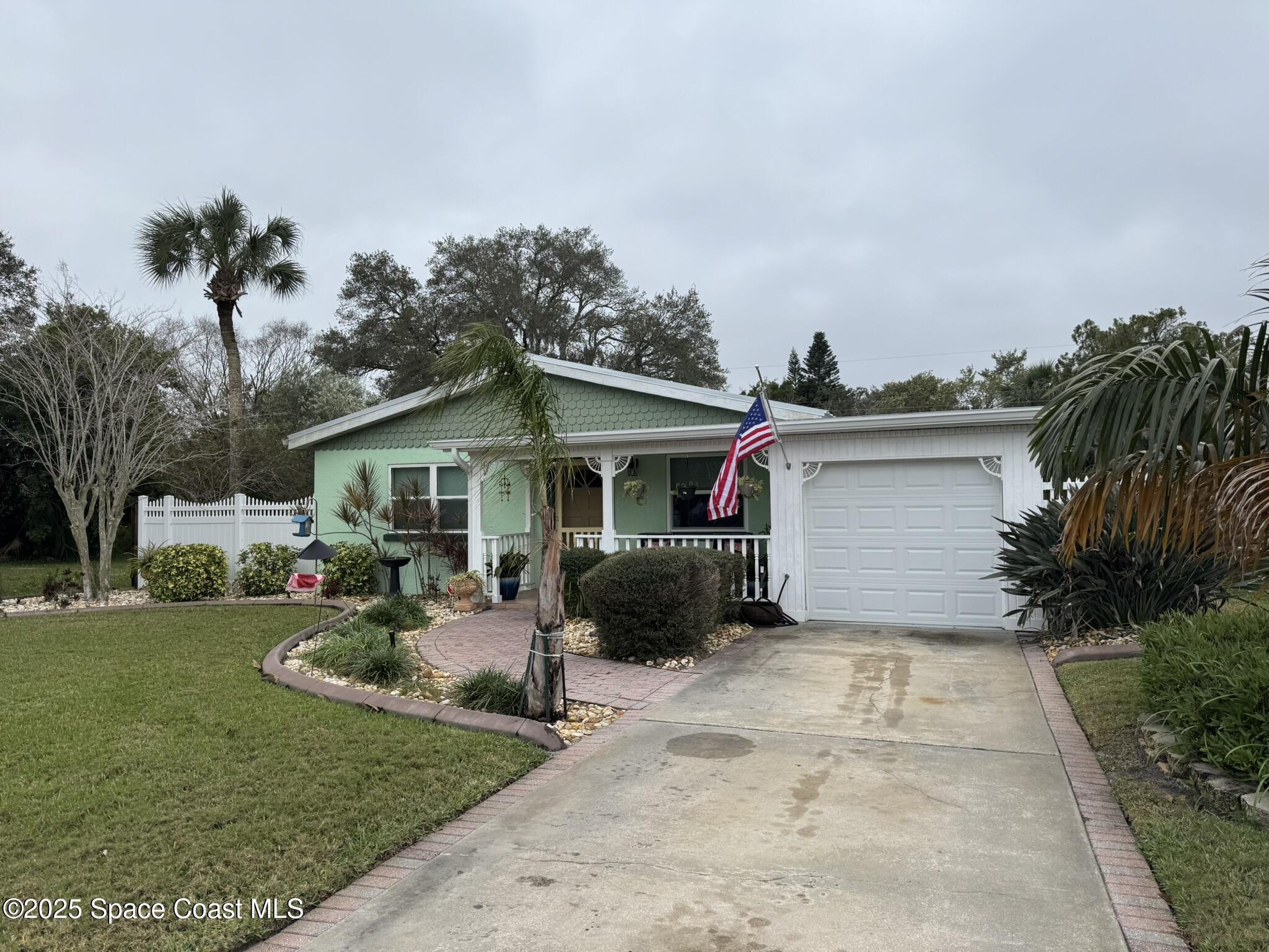701 Espanola Way Melbourne, FL 32901 - Photo 27 of 29 a front view of a house with garden