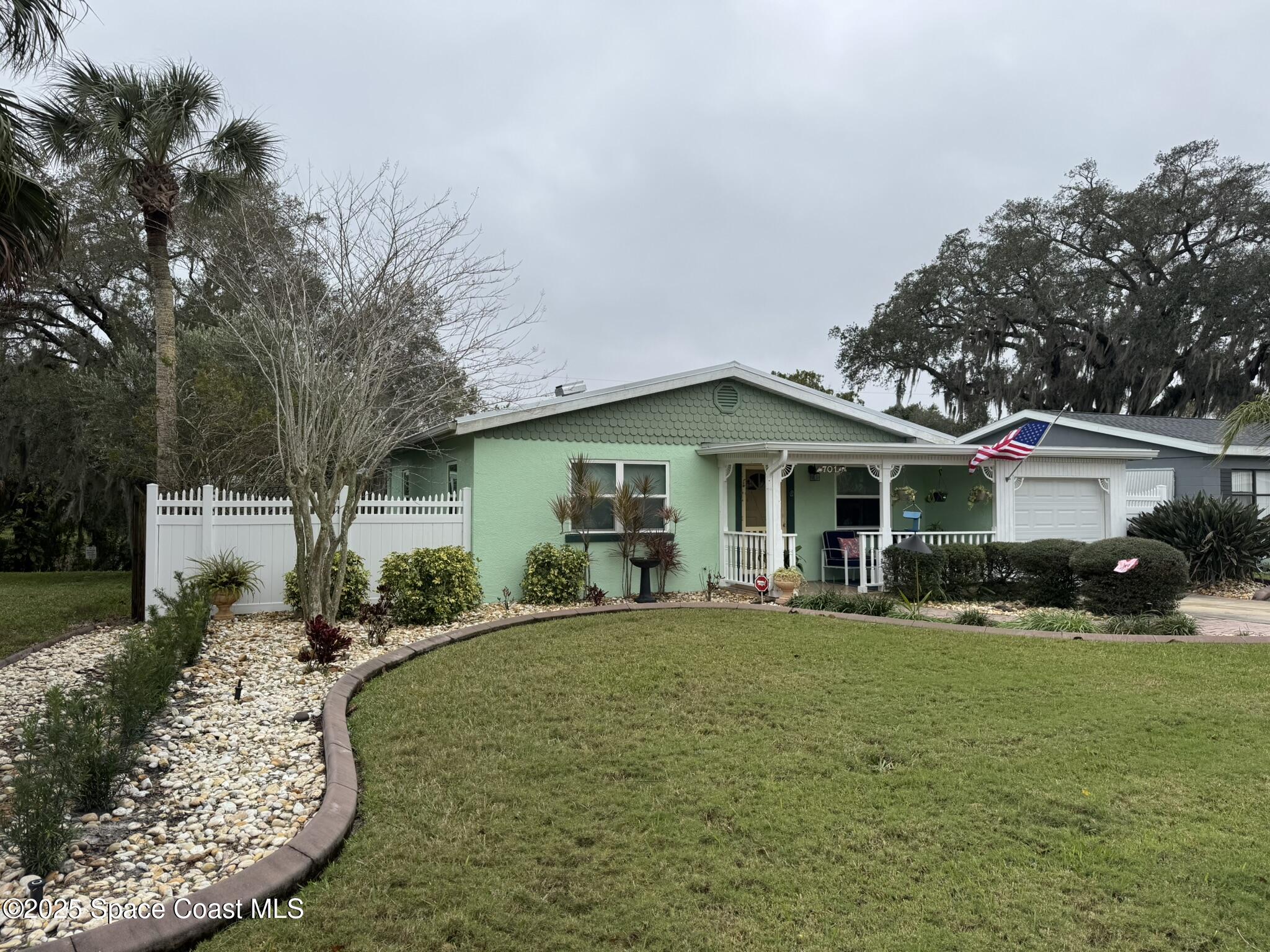 701 Espanola Way Melbourne, FL 32901 - Photo 28 of 29 a front view of a house with a yard porch and outdoor seating