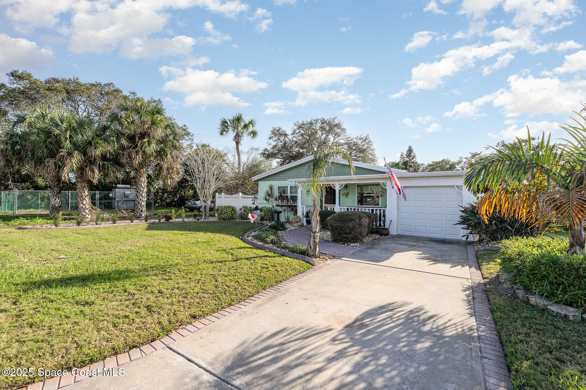 701 Espanola Way Melbourne, FL 32901 - Photo 3 of 29 a front view of a house with garden