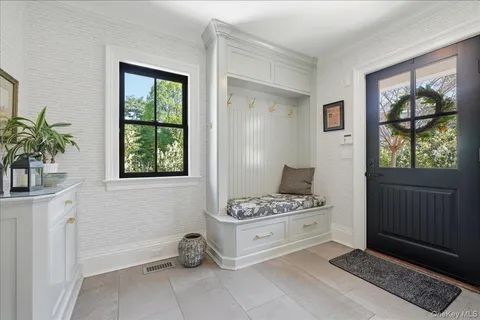 a white bed sitting in a bedroom next to a window