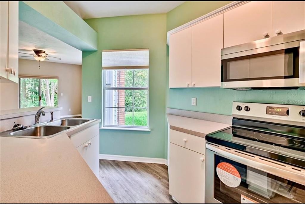 322 Northwest 50th Boulevard Gainesville, FL 32607 - Photo 11 of 19 a kitchen with a sink and a stove top oven