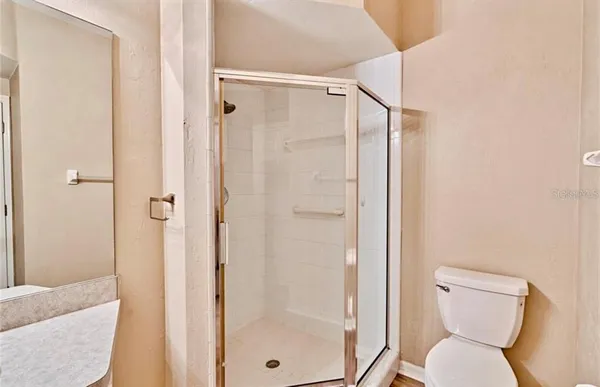 a bathroom with a shower and a toilet