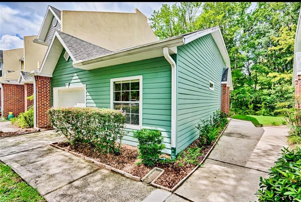 322 Northwest 50th Boulevard Gainesville, FL 32607 - Photo 2 of 19 a front view of a house with garden