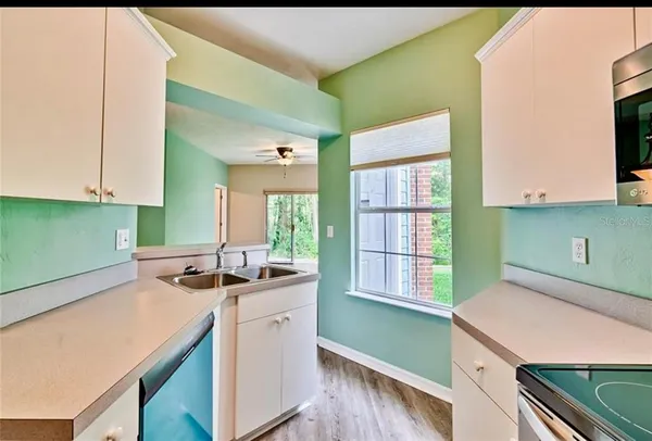 a kitchen that has a sink and a stove in it