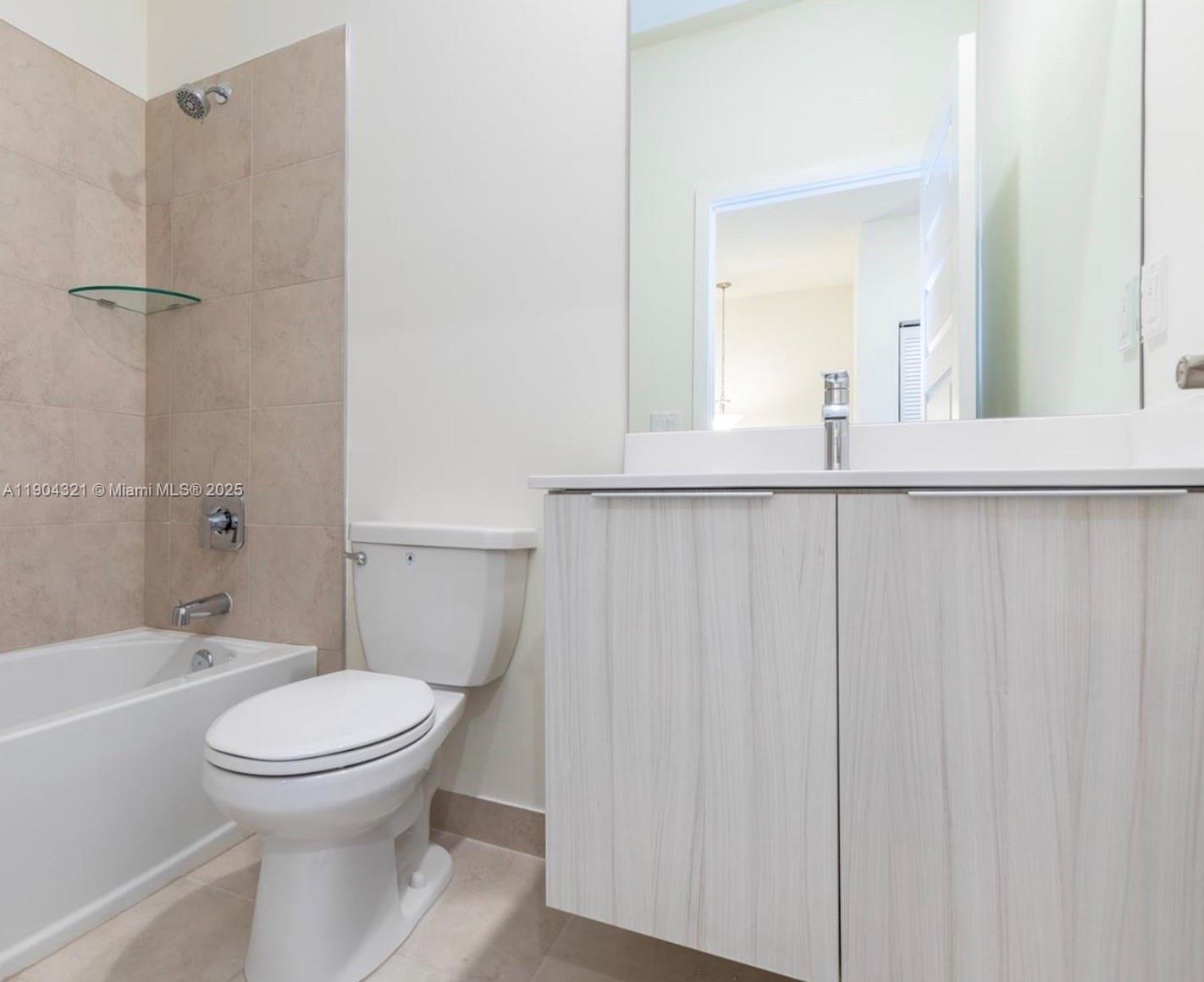 15861 Northwest 90th Court, Unit 15861 Miami Lakes, FL 33018 - Photo 20 of 31 a bathroom with a toilet a sink and shower