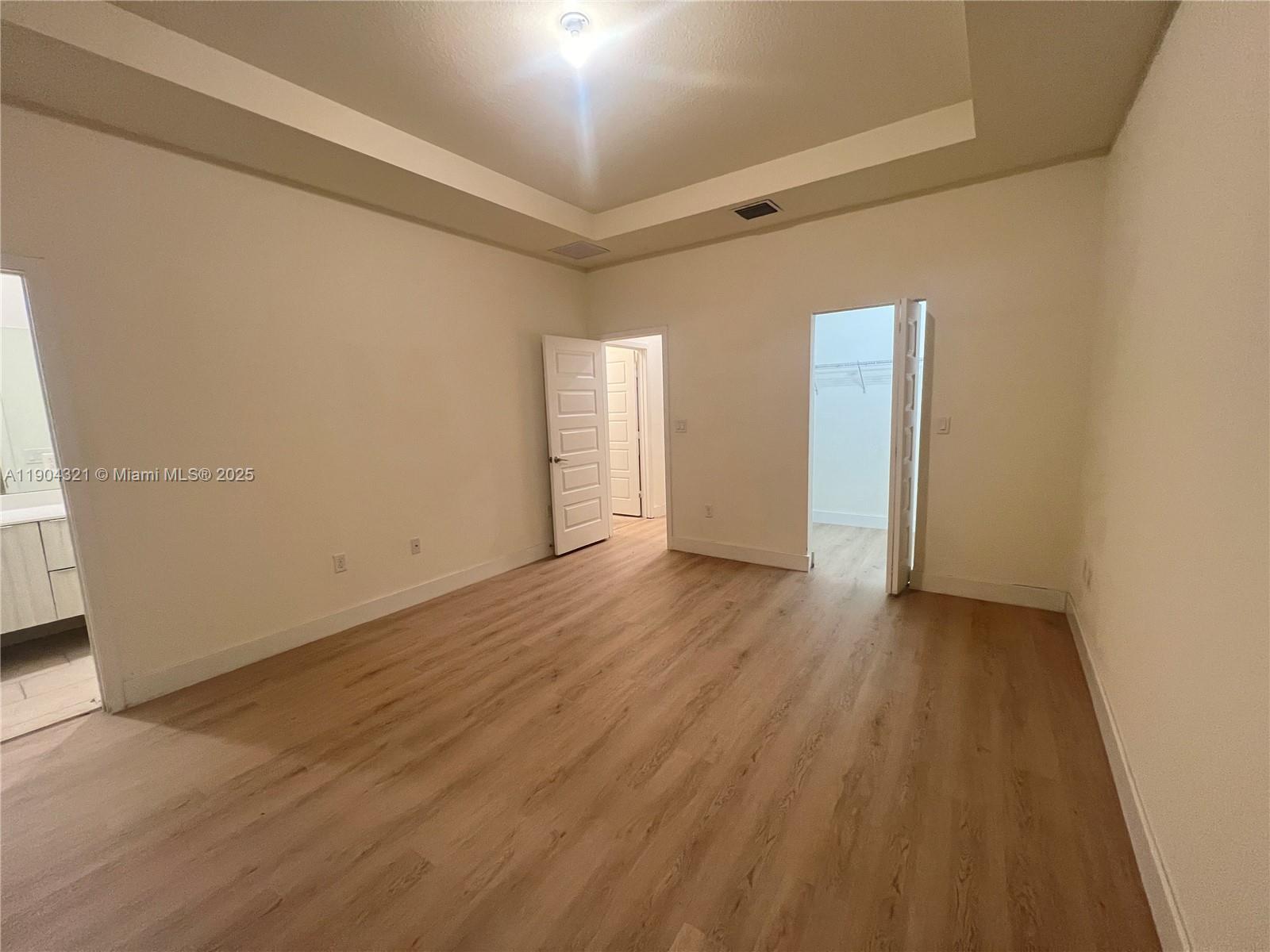 15861 Northwest 90th Court, Unit 15861 Miami Lakes, FL 33018 - Photo 25 of 31 a view of an empty room and wooden floor