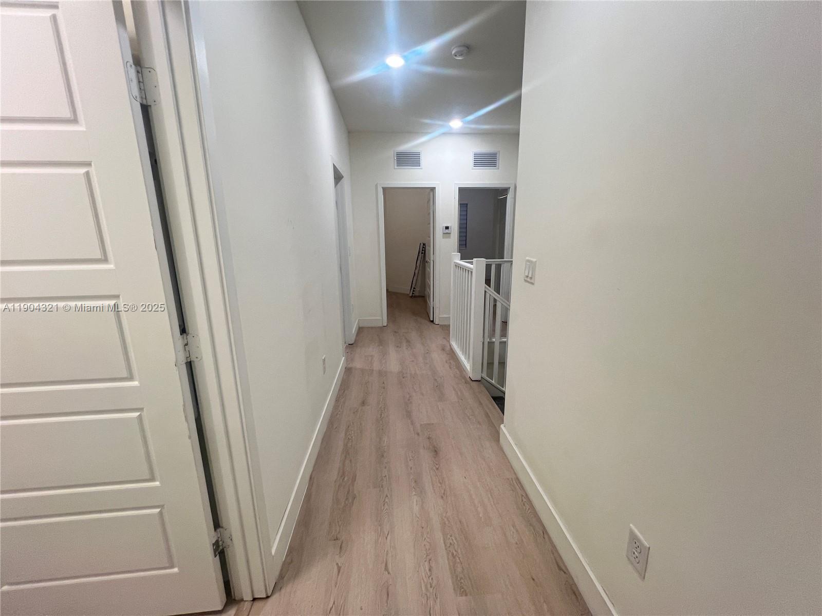 15861 Northwest 90th Court, Unit 15861 Miami Lakes, FL 33018 - Photo 29 of 31 a view of a hallway with wooden floor and entryway