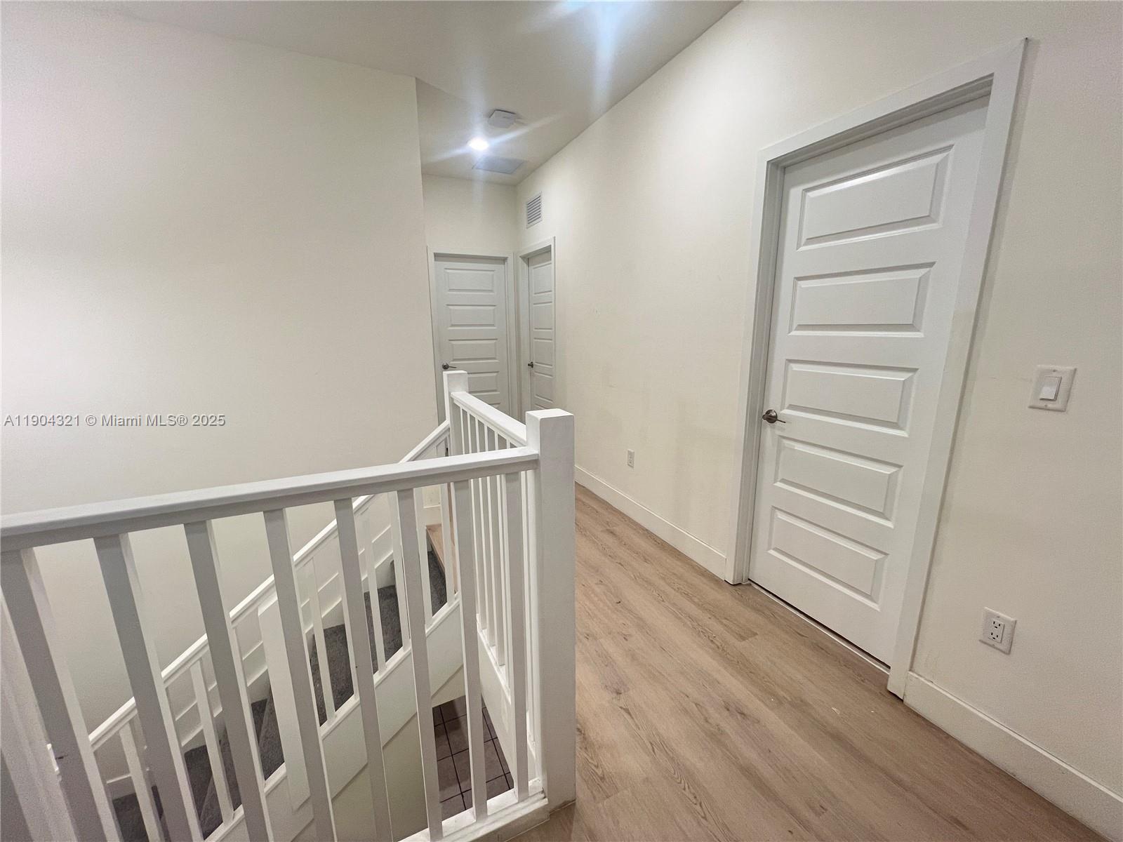 15861 Northwest 90th Court, Unit 15861 Miami Lakes, FL 33018 - Photo 30 of 31 a view of a hallway with wooden floor