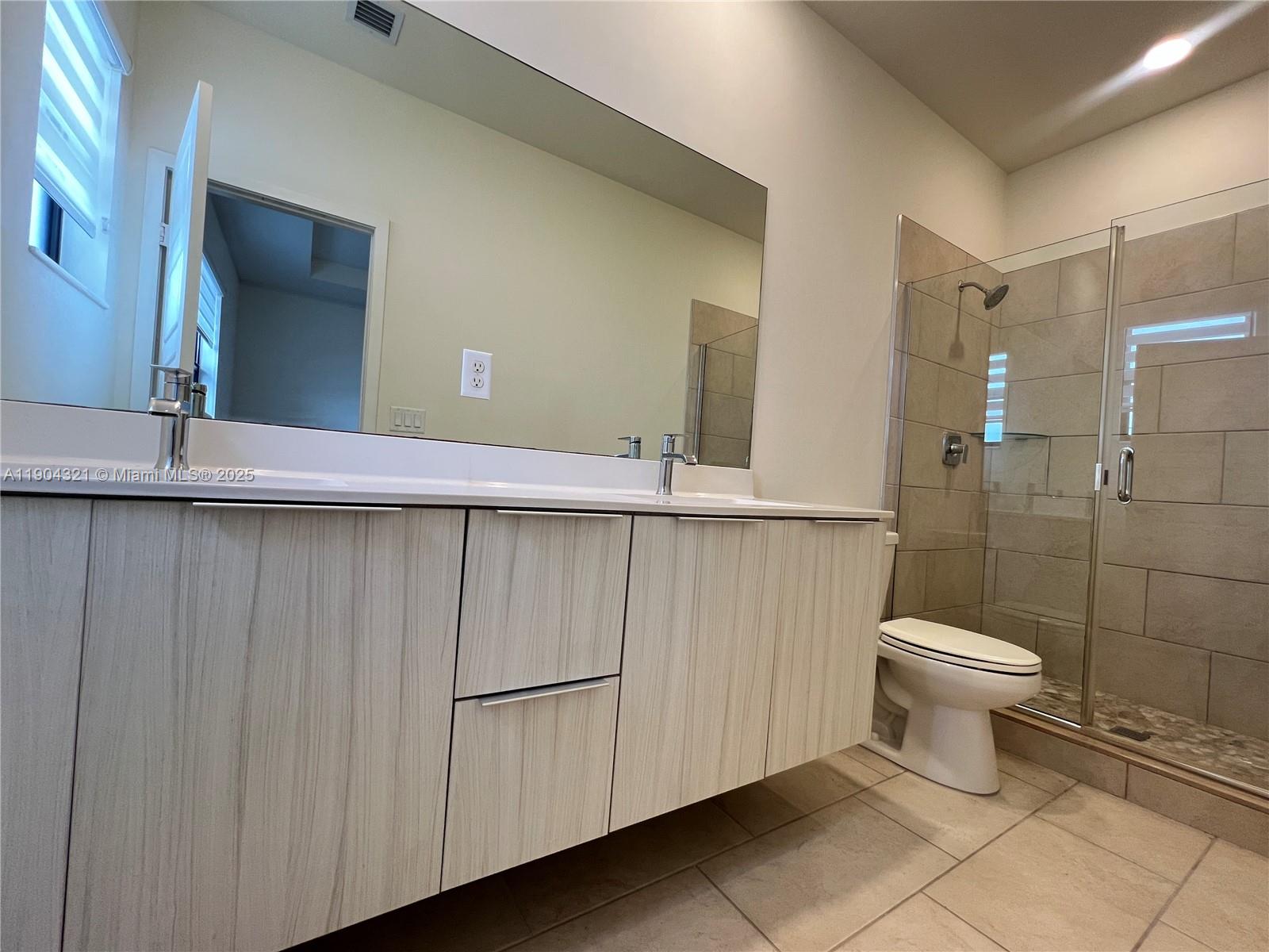 15861 Northwest 90th Court, Unit 15861 Miami Lakes, FL 33018 - Photo 6 of 31 a bathroom with a sink a toilet and shower