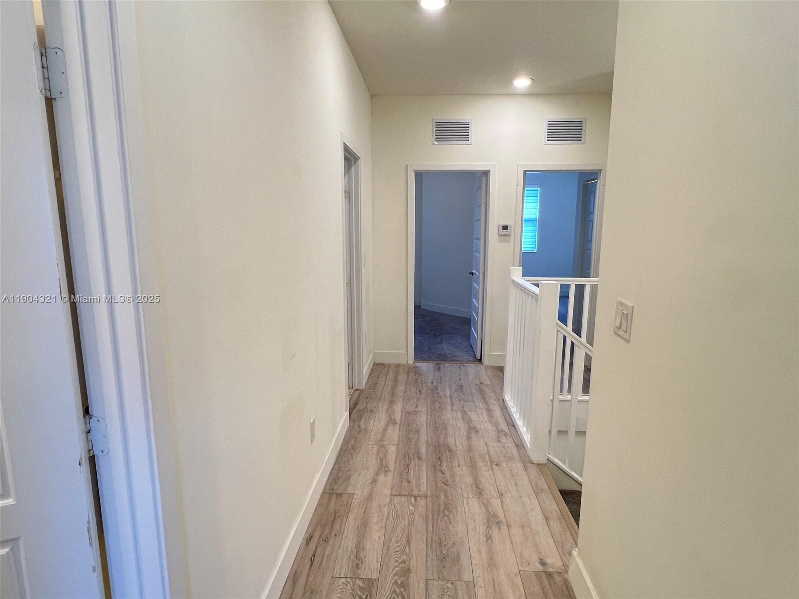 15861 Northwest 90th Court, Unit 15861 Miami Lakes, FL 33018 - Photo 8 of 31 a view of a hallway with wooden floor