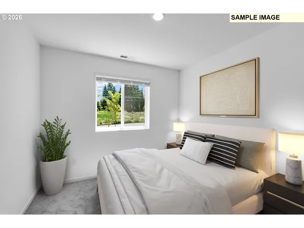 a bedroom with a bed and a potted plant