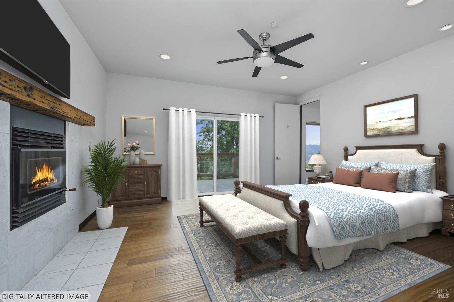 31000 Pine Mountain Road Cloverdale, CA 95425 - Photo 21 of 64 A serene primary suite featuring a fireplace, deck access, and peaceful natural outlooks.