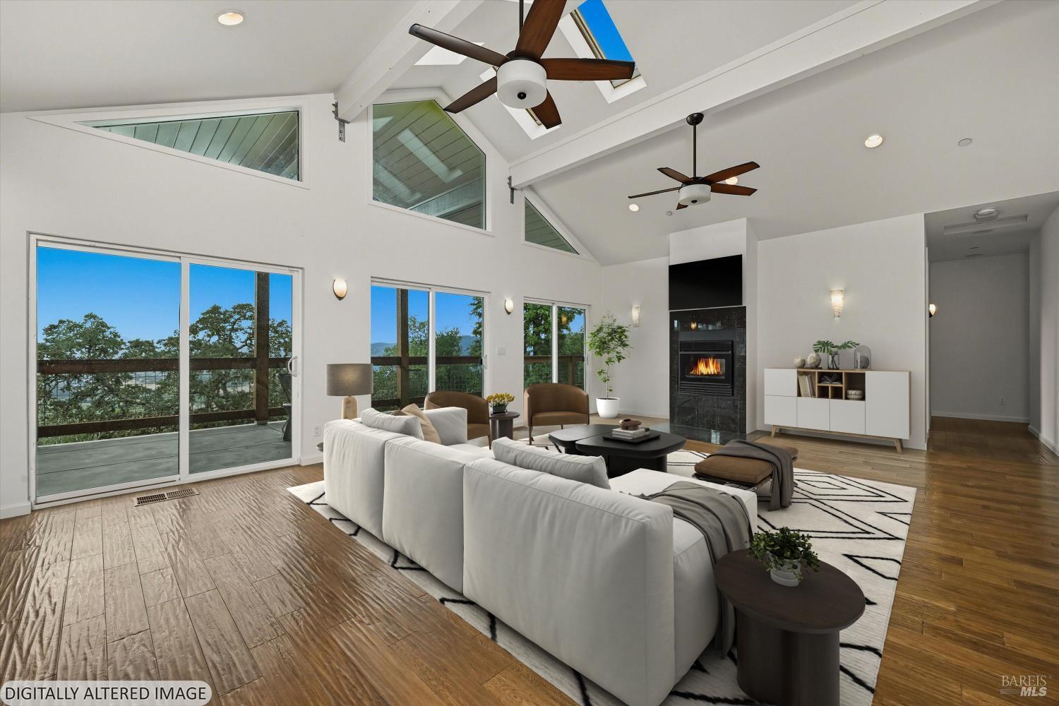 31000 Pine Mountain Road Cloverdale, CA 95425 - Photo 9 of 64 A spacious, light-filled living room with vaulted ceilings, large windows, and seamless indoor-outdoor connection.