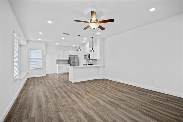 a view of kitchen with granite countertop cabinets and wooden floor