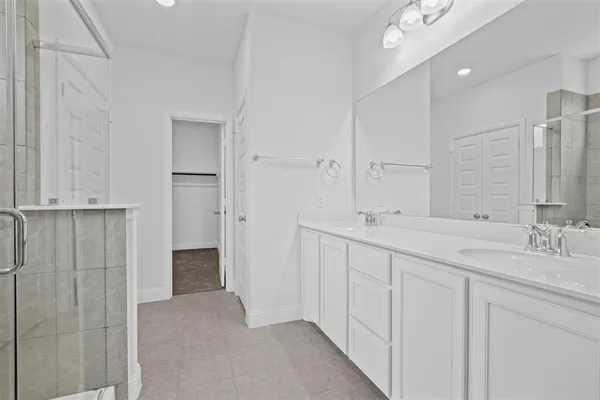 a bathroom with double sink and a mirror