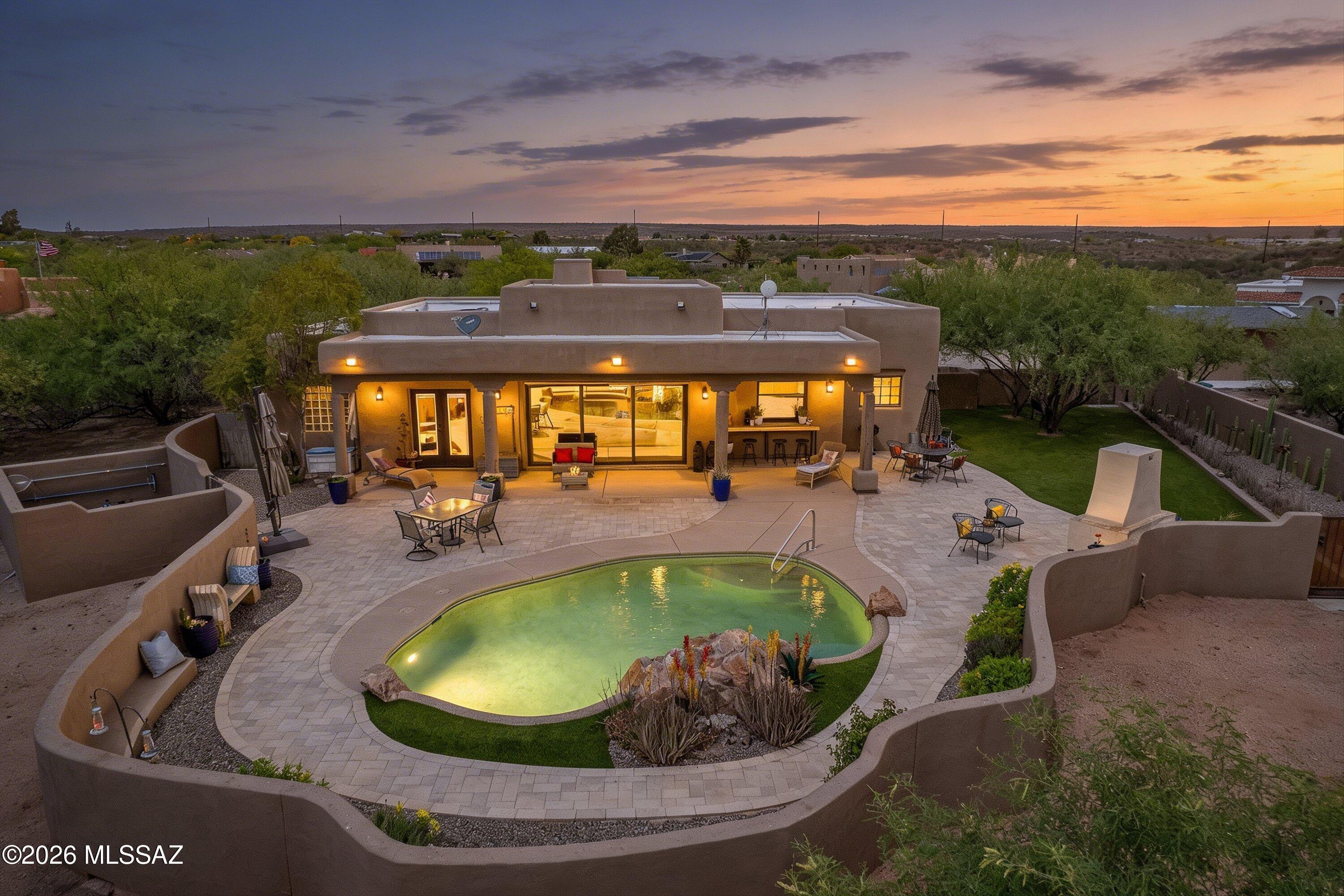 4760 East Wagon Train Road Tucson, AZ 85739 - Photo 5 of 38 a view of a swimming pool with a patio