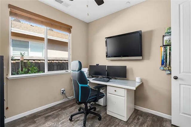 a view of a workspace with furniture and a window