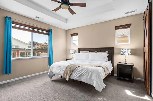 a spacious bedroom with a bed and a window