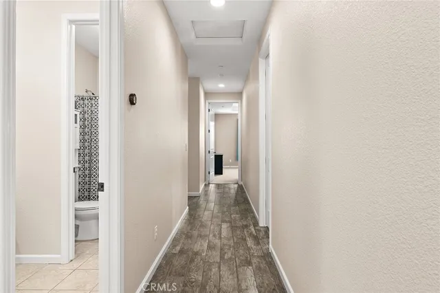 a view of a hallway with wooden floor