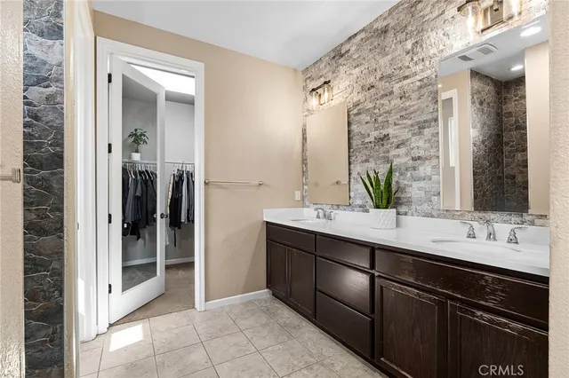 a bathroom with a double vanity sink and a mirror