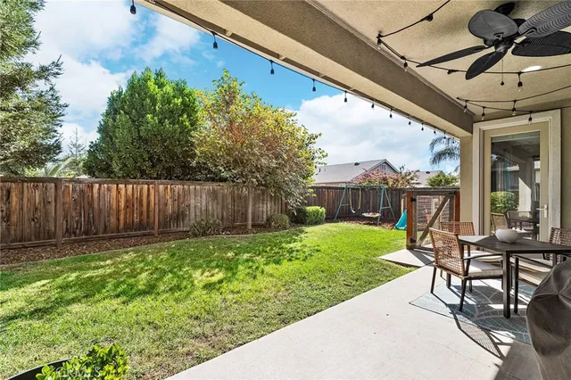 a view of a house with backyard porch and sitting area