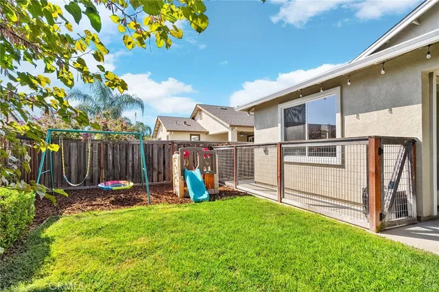 a view of a house with a wooden fence