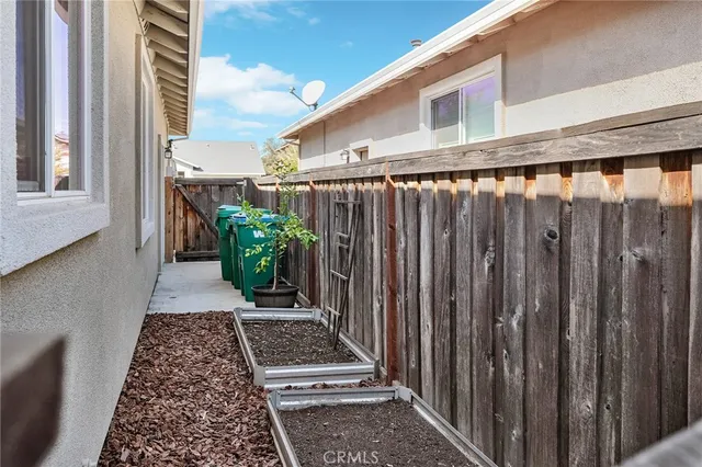 a view of a balcony with wooden floor and fence