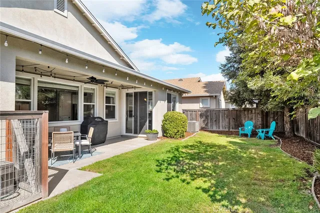 a view of a house with backyard porch and sitting area