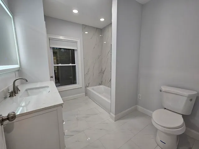 a bathroom with a sink toilet and tub