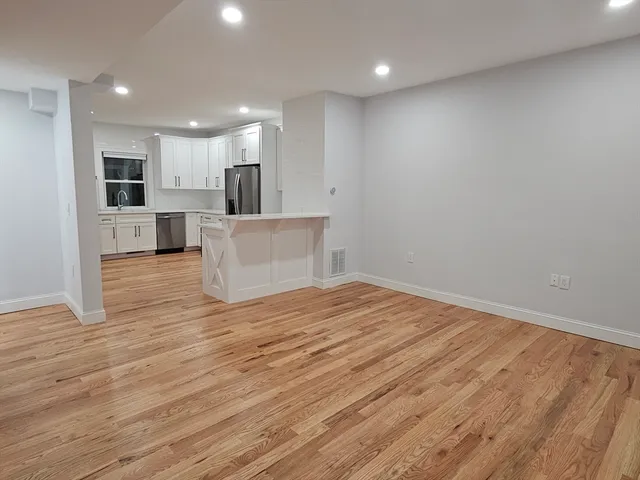 a view of kitchen with kitchen island microwave and refrigerator