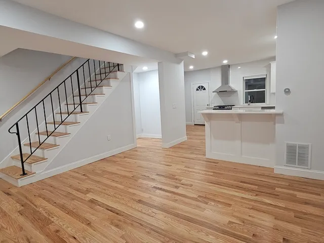 a view of kitchen with wooden floor and electronic appliances
