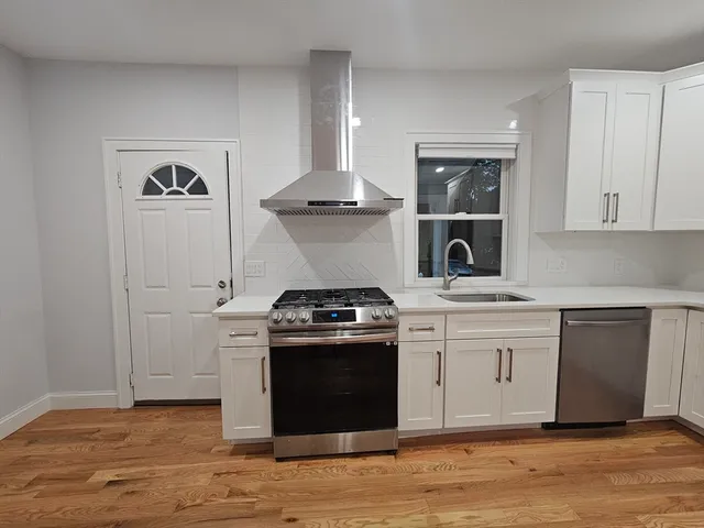 a kitchen with a stove and cabinets