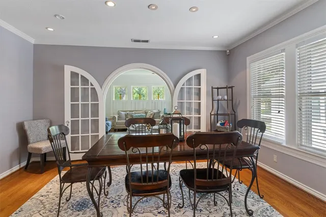 a view of a dining room with furniture a rug and wooden floor