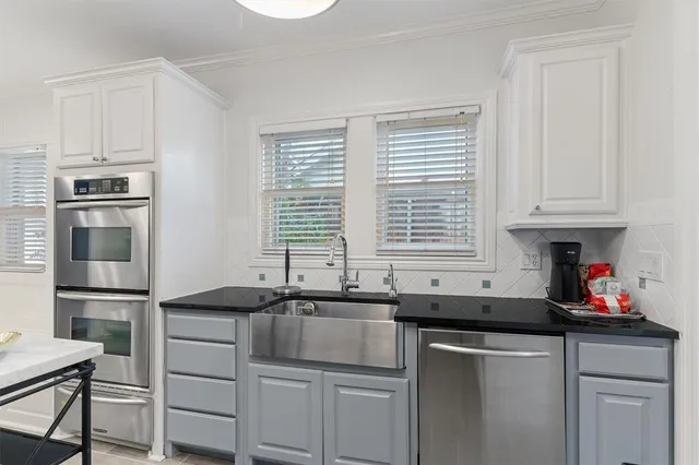 a kitchen with stainless steel appliances granite countertop a sink and a cabinets