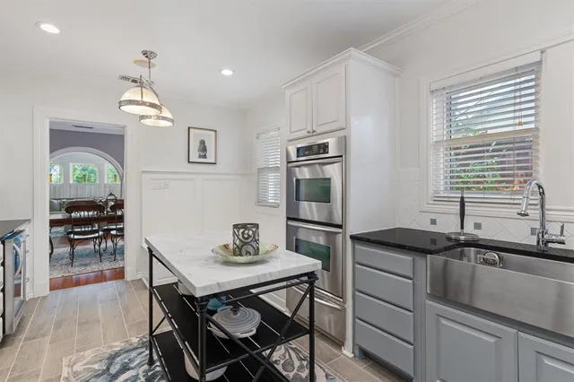 a kitchen with a sink stove and microwave