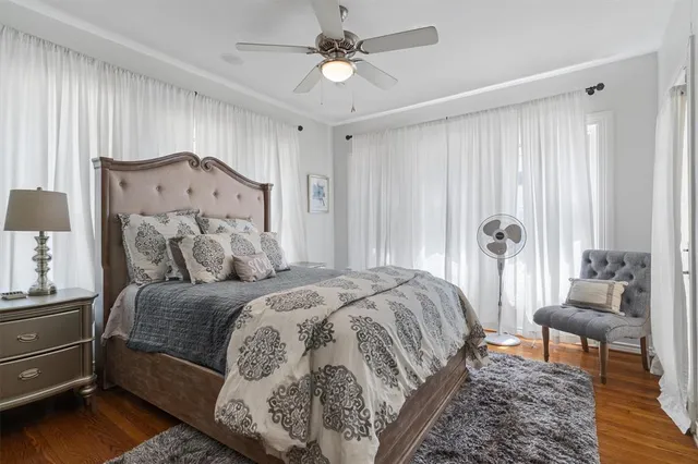 a spacious bedroom with a bed and a chandelier