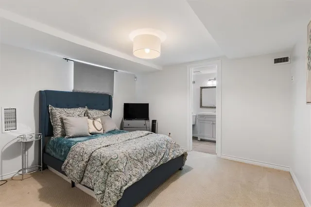 a bedroom with a bed and a television