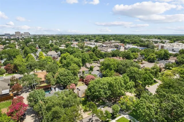 an aerial view of residential house with outdoor space and trees all around