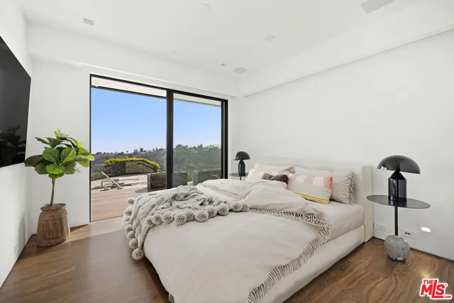 a bedroom with a bed and a potted plant