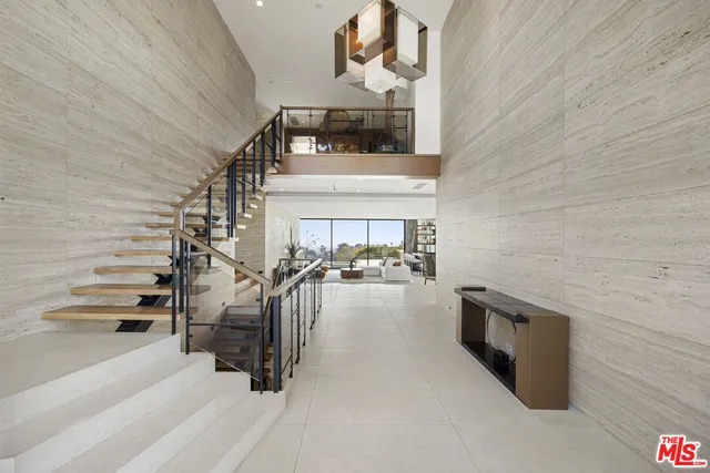 a view of a livingroom with furniture and floor to ceiling window