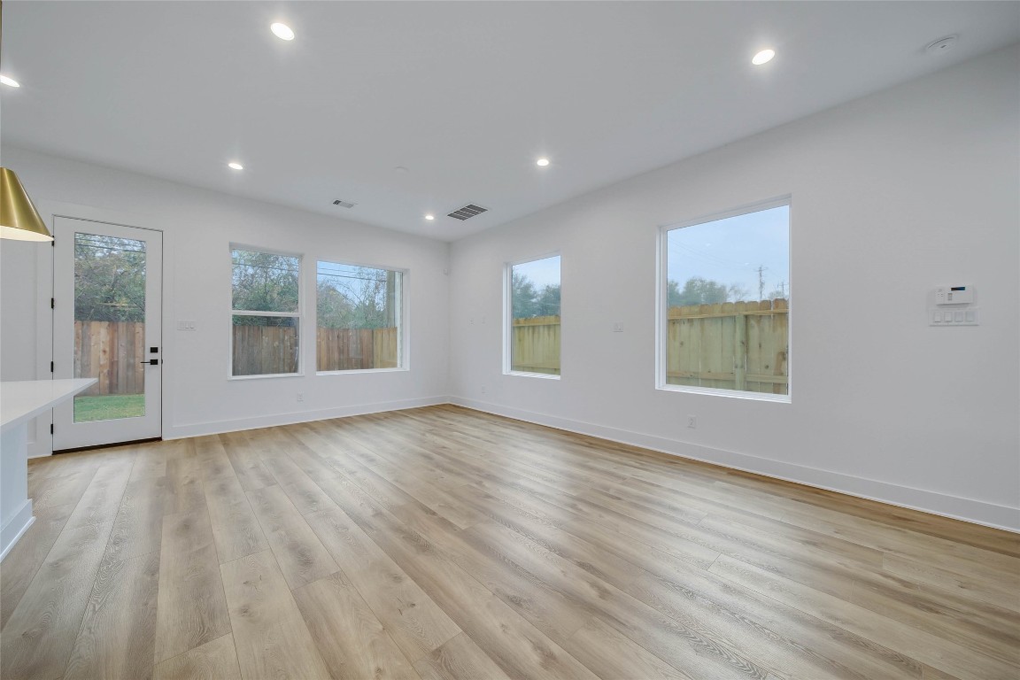 7709 Inwood Grove Lane Houston, TX 77088 - Photo 11 of 36 an empty room with wooden floor and windows
